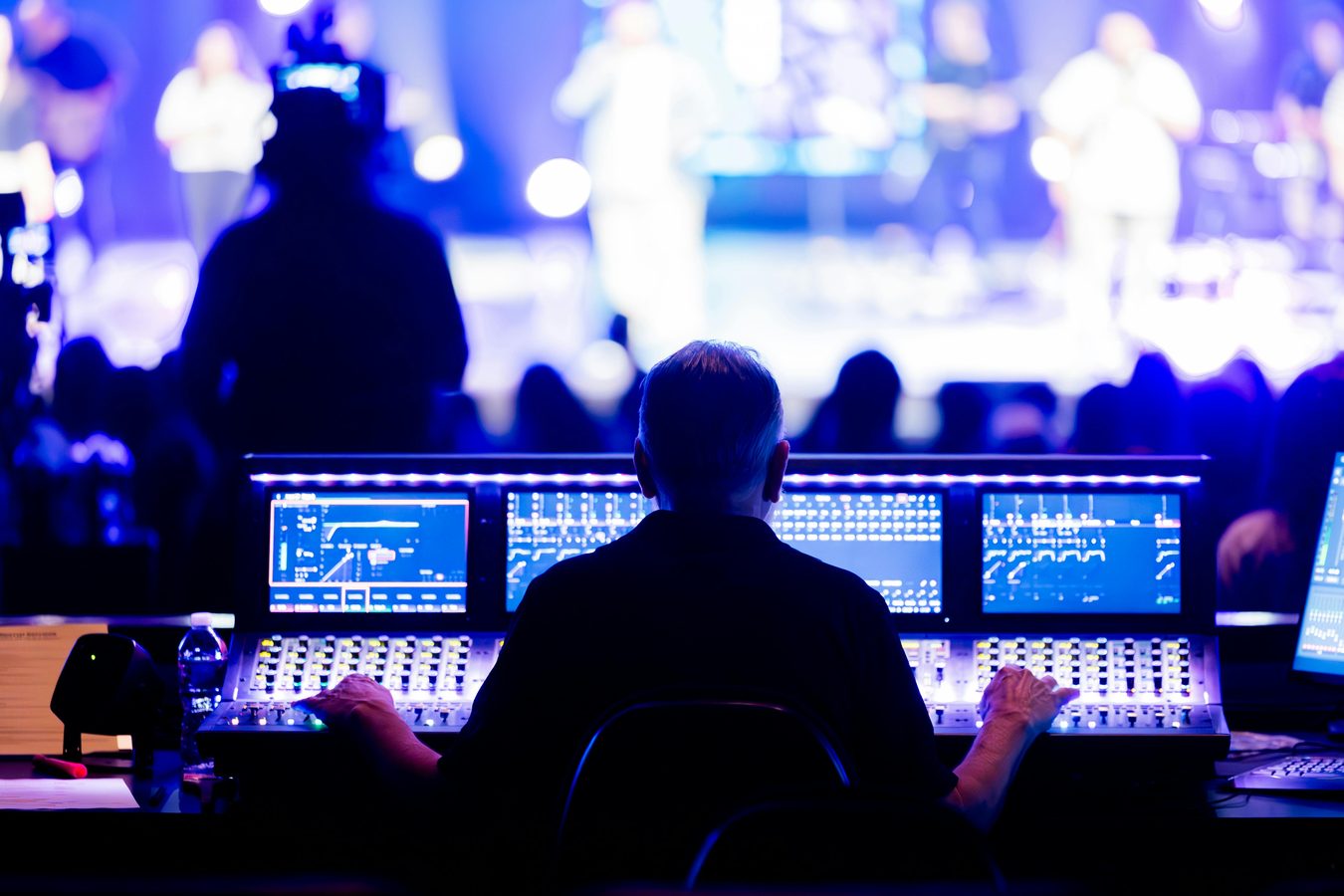 Front of house engineer mixing live audio during a concert event